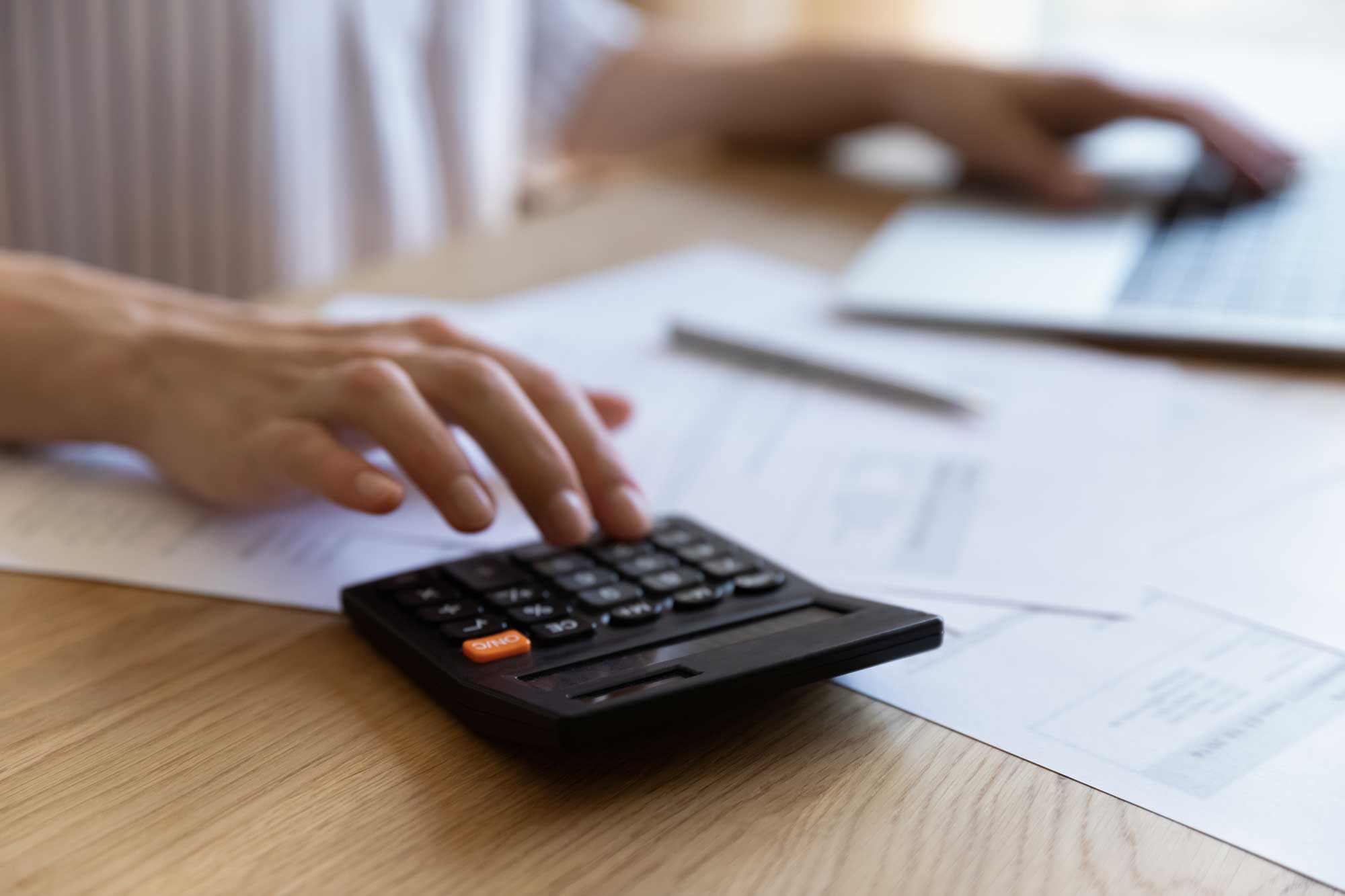 hand-of-finance-professional-woman-using-calculator