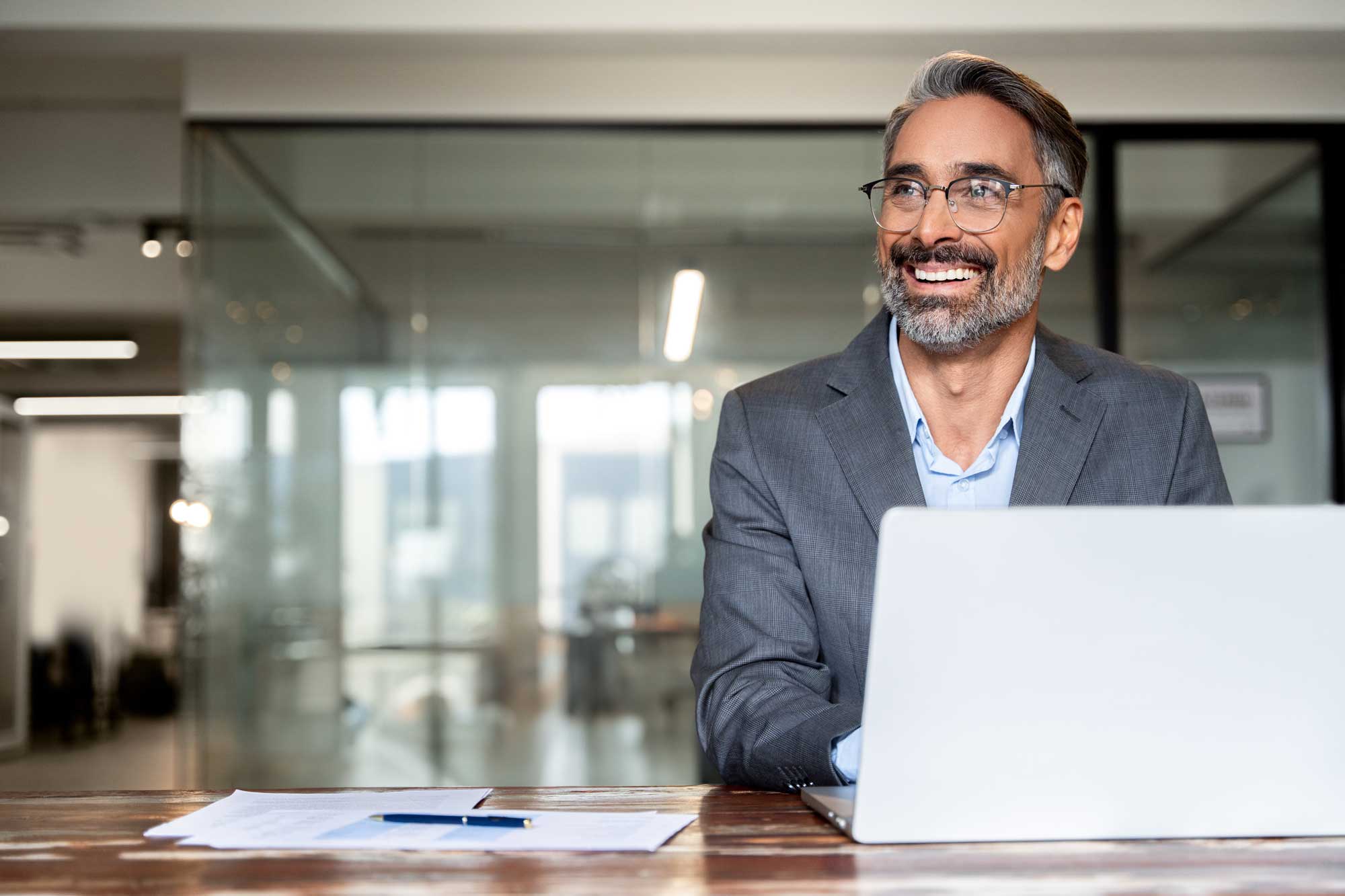 portrait_of_mature_business_man_ceo_trader_using_laptop